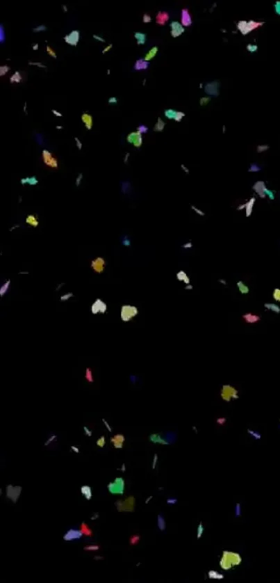 Colorful heart-shaped confetti on a black background.