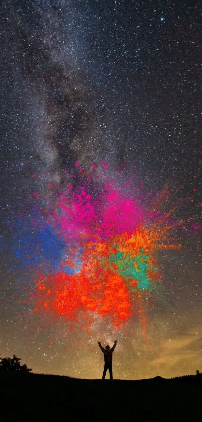 Colorful night sky with person silhouette beneath cosmic explosion.