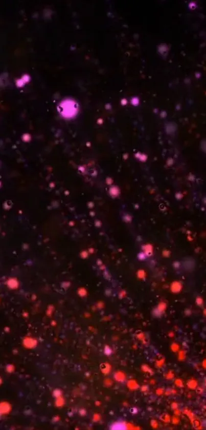 Vibrant cosmic particle wallpaper with red and purple hues.