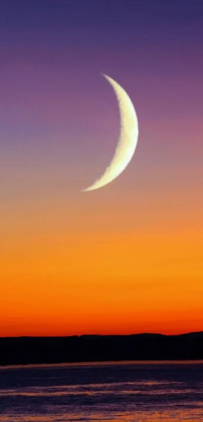 Crescent moon over vibrant sunset ocean landscape.