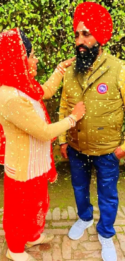 Couple in traditional attire with vibrant red and green background.