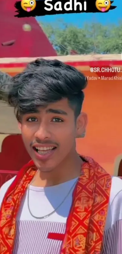 Young person in vibrant traditional attire smiling enthusiastically outdoors.