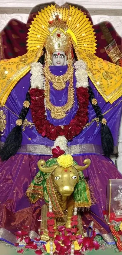 Vibrant deity with purple and gold attire, adorned with flowers.