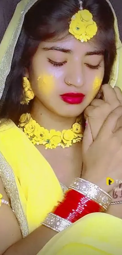 Woman in vibrant traditional yellow attire with floral adornments.