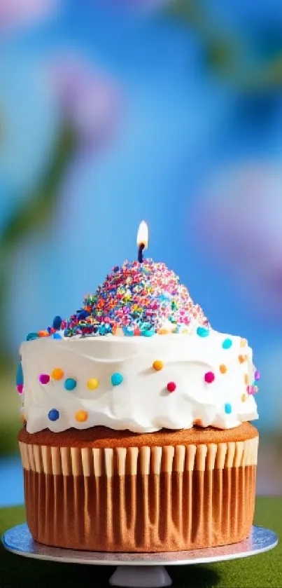 Cupcake with colorful sprinkles on a vibrant blue background.