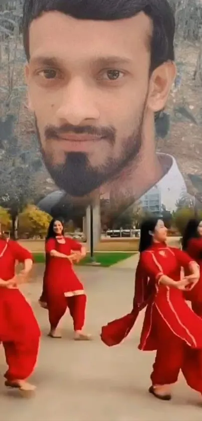 Dancers in red with a large portrait above.