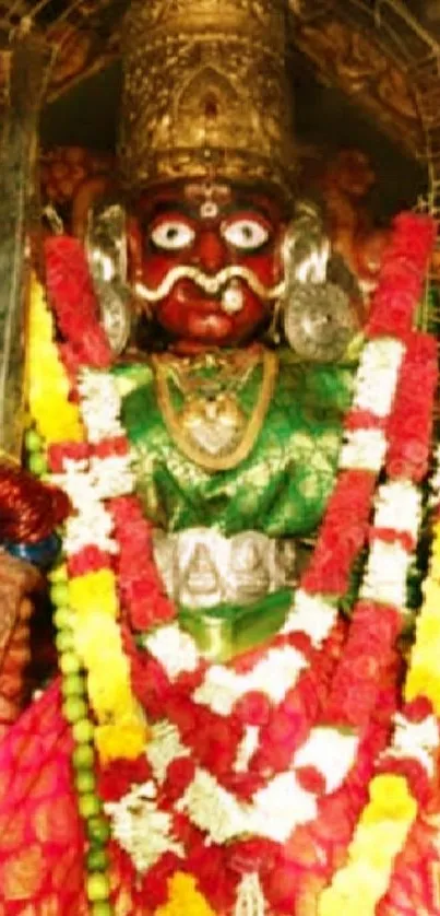 Vibrant deity adorned with garlands on a spiritual mobile wallpaper.