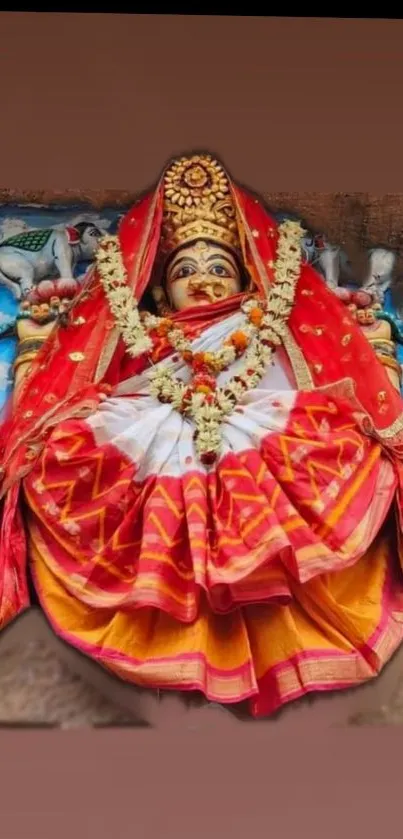 Colorful deity artwork in vibrant red attire.