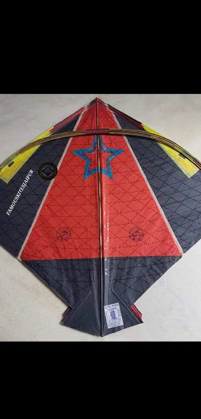Colorful delta kite with star pattern on phone wallpaper.