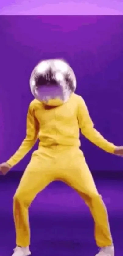 Dancing figure in yellow with disco ball head on a purple background.