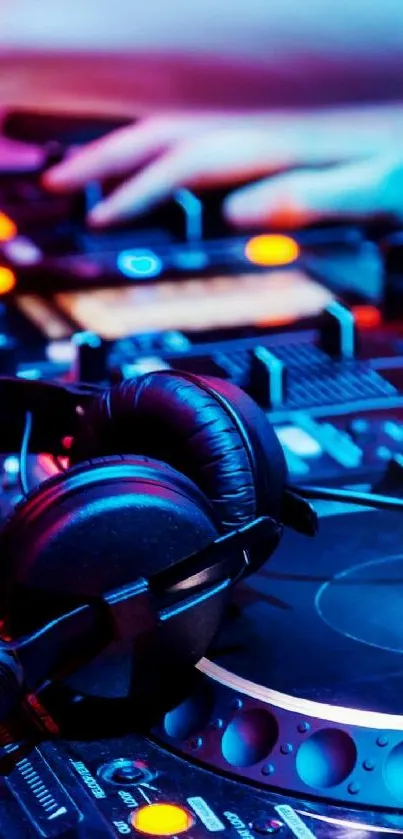 Vibrant DJ mixing station with headphones and neon lights.