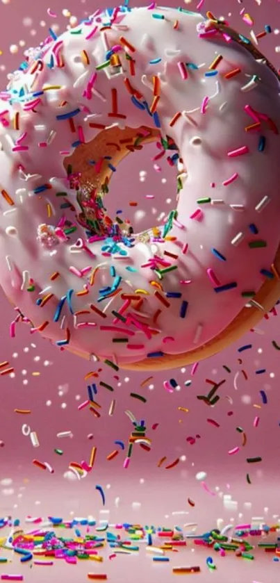 Colorful donut with sprinkles on a pink background.