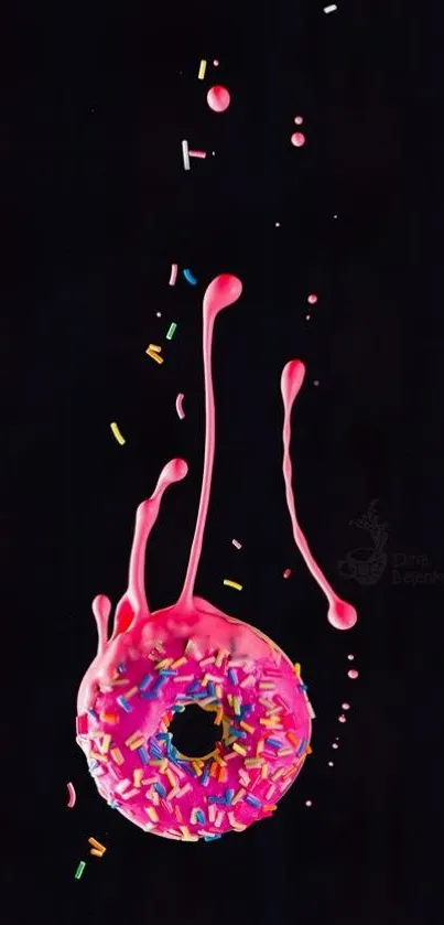 Pink iced donut with sprinkles on dark background wallpaper.