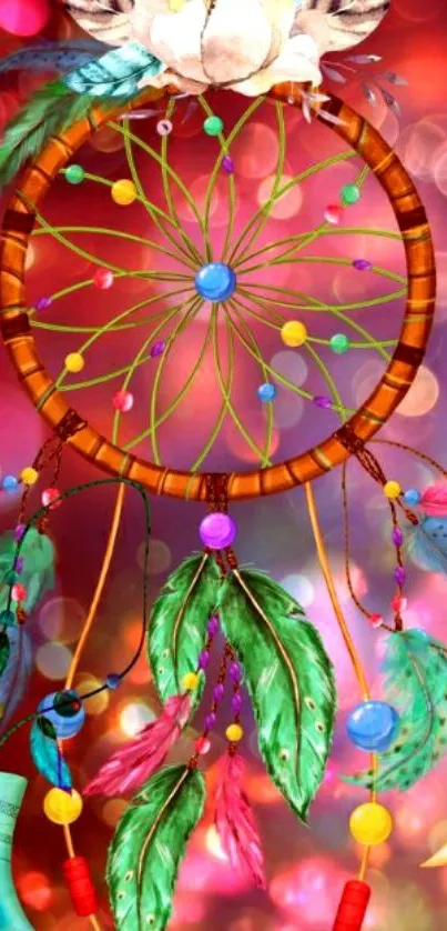 Vibrant dreamcatcher with feathers on pink bokeh background.