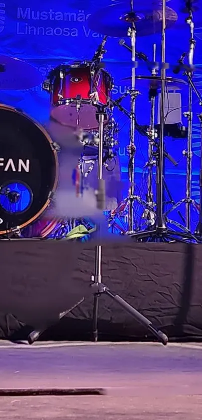 Colorful drum set on a blue stage background with musical instruments.