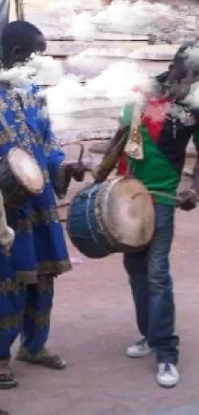 Traditional drummers in colorful attire performing outdoors.