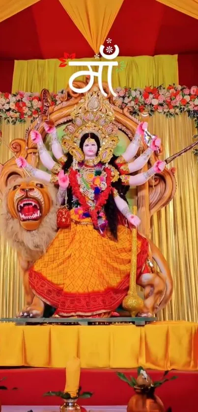 Colorful Durga Puja display with Hindu goddess statue and floral decor.