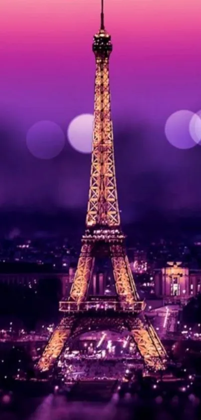 Eiffel Tower at night with vibrant purple lights.