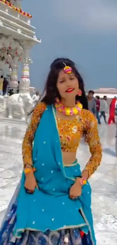 Woman in vibrant traditional attire at a festival.