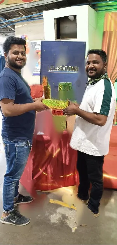 Two people holding colorful gifts at a vibrant celebration event indoors.