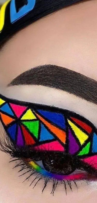 Close-up of eye with vibrant geometric makeup design.