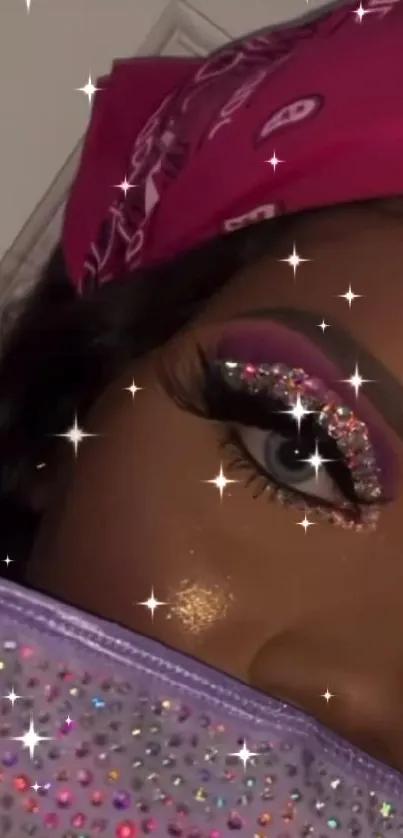 Close-up of glittery eye makeup with pink bandana.