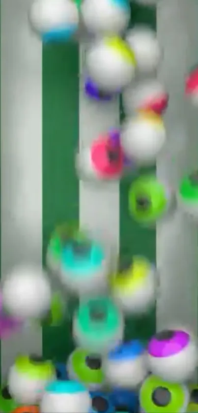 Colorful spheres falling on a green and white striped background.