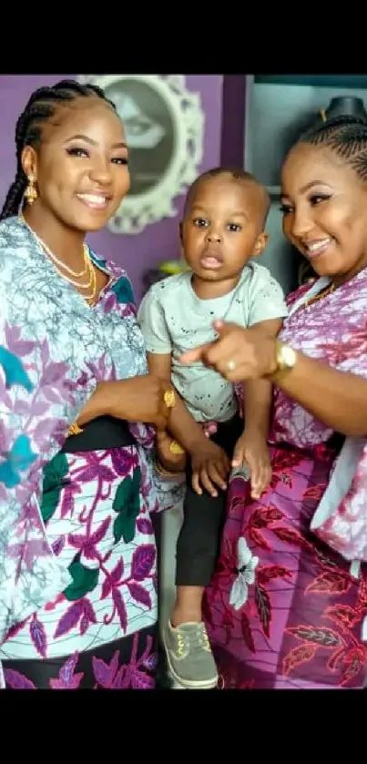 Women and child in vibrant floral attire, smiling warmly.