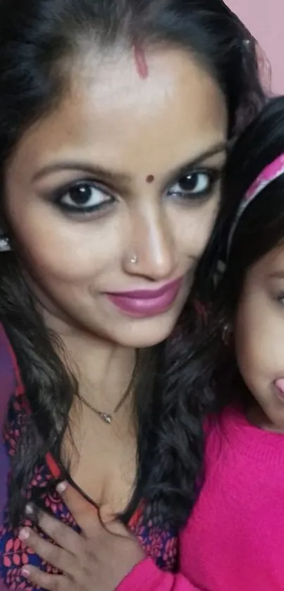 Woman and child smiling in a close family portrait.