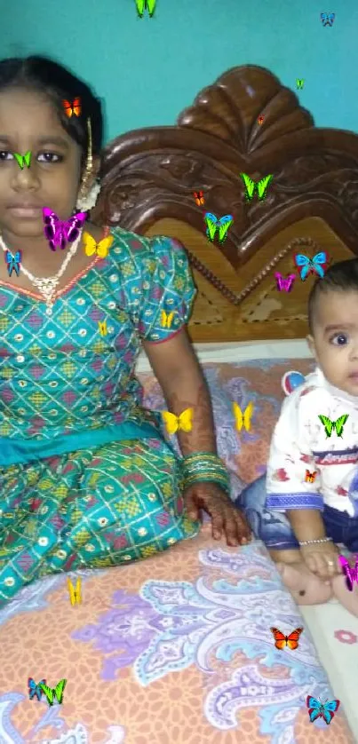 Two children in colorful attire on a bed with vibrant patterns.