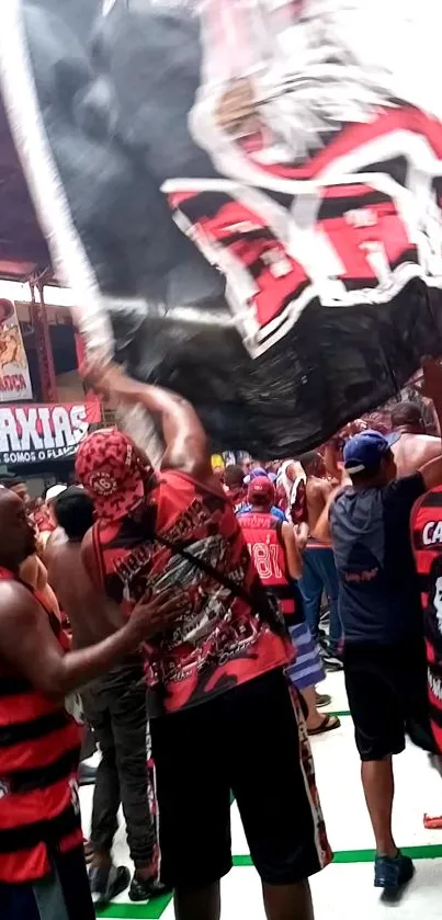 Crowded fan celebration with red jerseys.