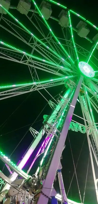 Vibrant Ferris wheel with green lights against a night sky.