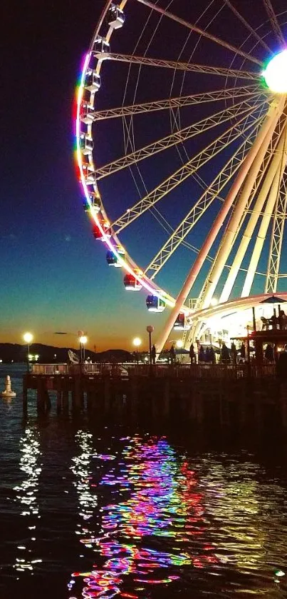 Night view of a ferris wheel with colorful reflections on the water.