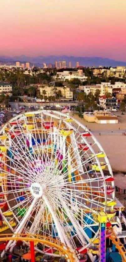 Colorful Ferris wheel at beach sunset with vibrant sky.