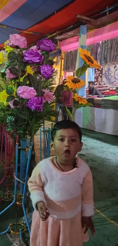 Child at a colorful festival with vibrant flowers.