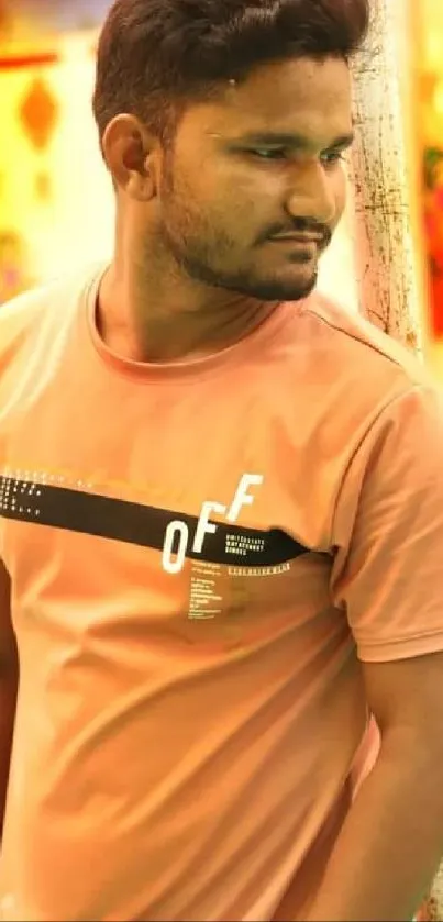 Man in peach shirt with colorful festive background.