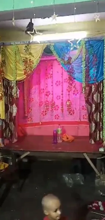 Festive stage with vibrant drapes and traditional decorations.