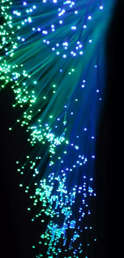 Fiber optic wallpaper with glowing blue and green lights on a dark background.