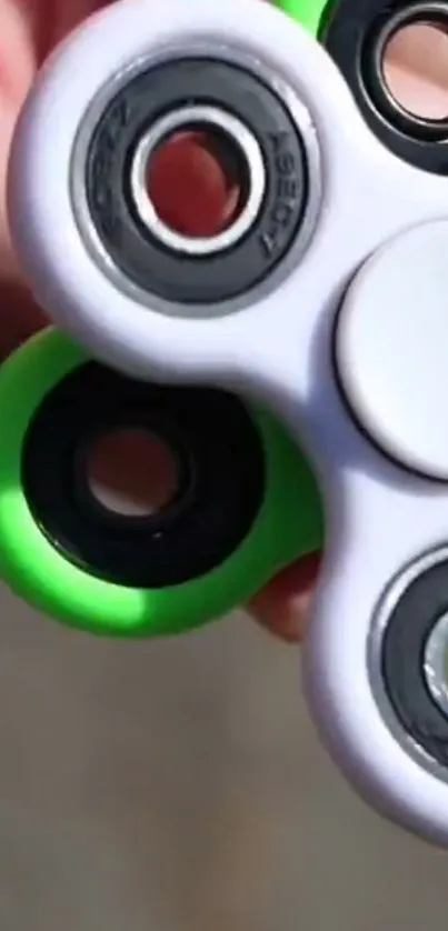 Close-up vibrant fidget spinner with green and black colors.