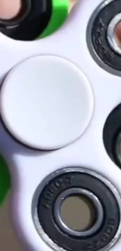 A vibrant fidget spinner with white and green accents.