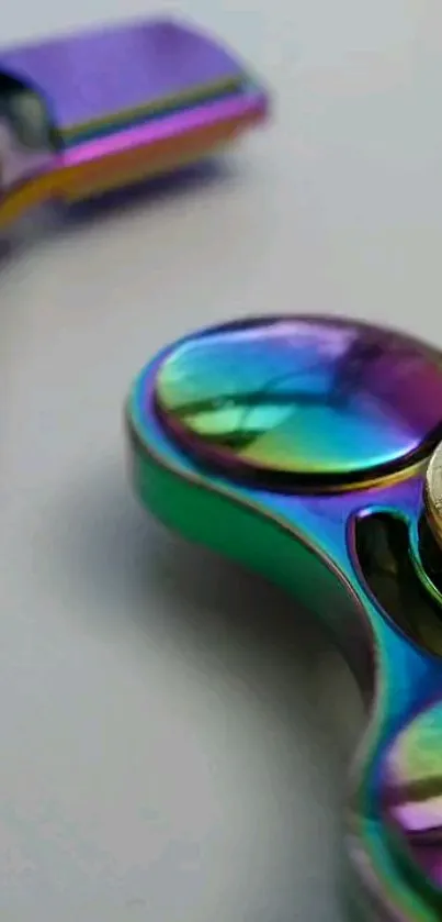 Colorful metallic fidget spinner on a blue background.