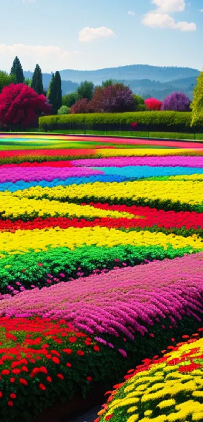 Vibrant multicolored flower field with scenic landscape and trees.