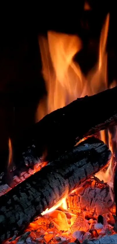 Vibrant orange flames over burning logs wallpaper.