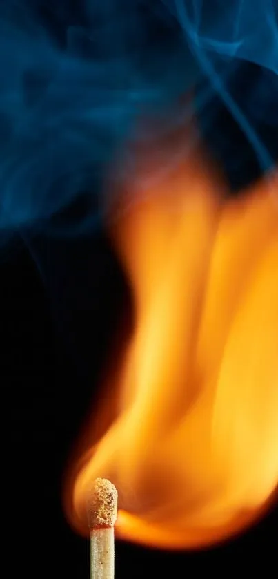 A vibrant orange flame on a matchstick with a smoky background.