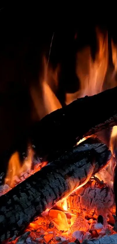 Close-up of glowing fireplace with burning logs and vibrant flames.