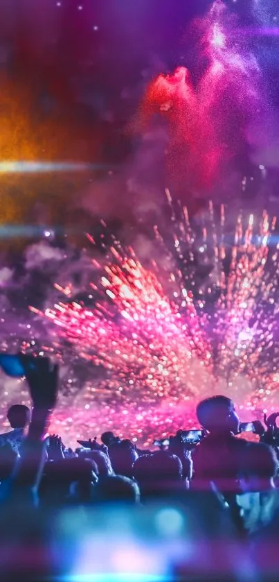 Vibrant fireworks explode over a lively outdoor concert with a cheering crowd.