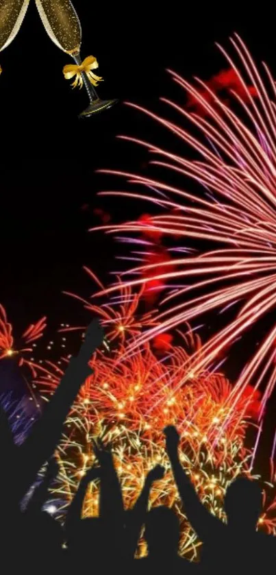 Silhouette crowd cheering at vibrant fireworks display with champagne glasses above.