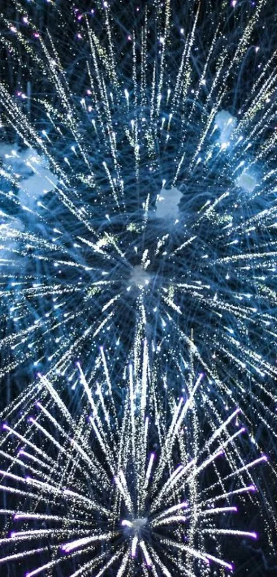 Dynamic fireworks display in vibrant blue hues for mobile wallpaper.