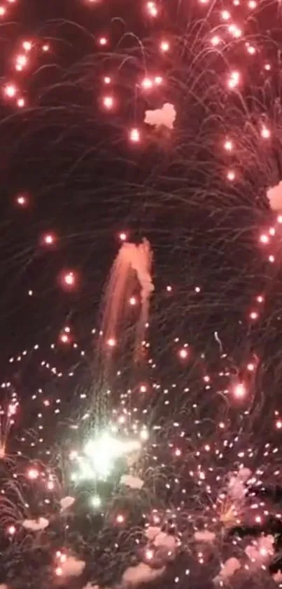 Vibrant red fireworks bursting in a dark night sky, creating a festive atmosphere.