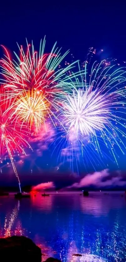 Vibrant fireworks over a calm night ocean.